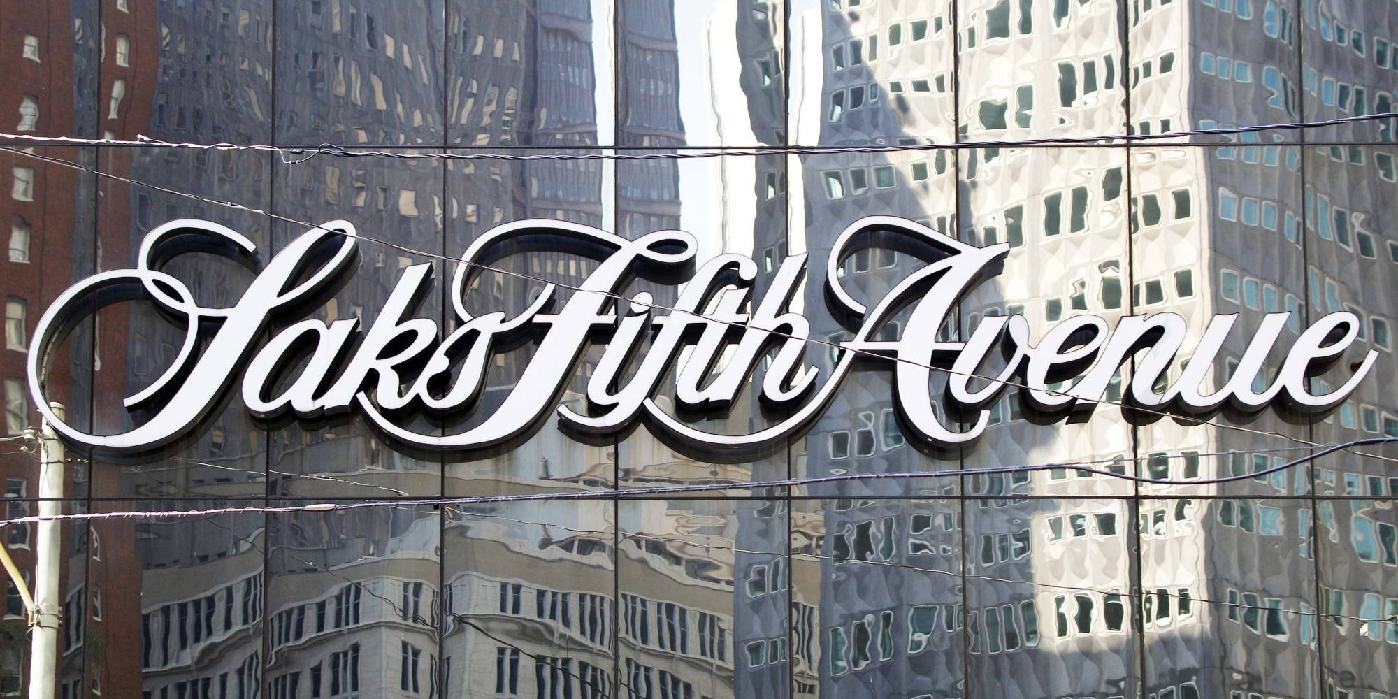 Downtown Pittsburgh buildings are reflected in the facade holding the sign on the Saks Fifth Avenue department store on Thursday, Oct. 6, 2011. Saks Fifth Avenue announced on Wednesday Oct. 5, 2011 that it will be closing this store after they couldn't raise the funding needed for improvements to the store. (AP Photo/Keith Srakocic)