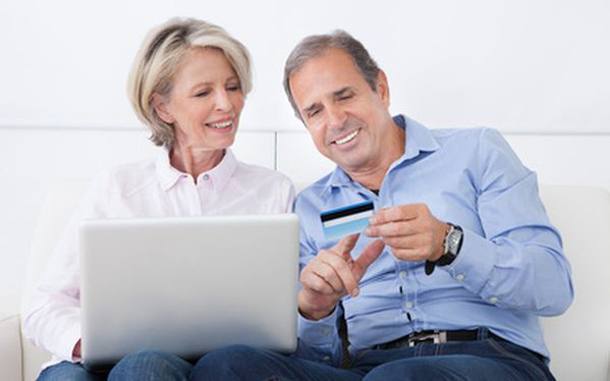 Happy Mature Couple Shopping Online On Laptop At Home